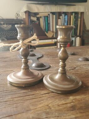 A Pair Of Antique Brass Candlestick Holders
